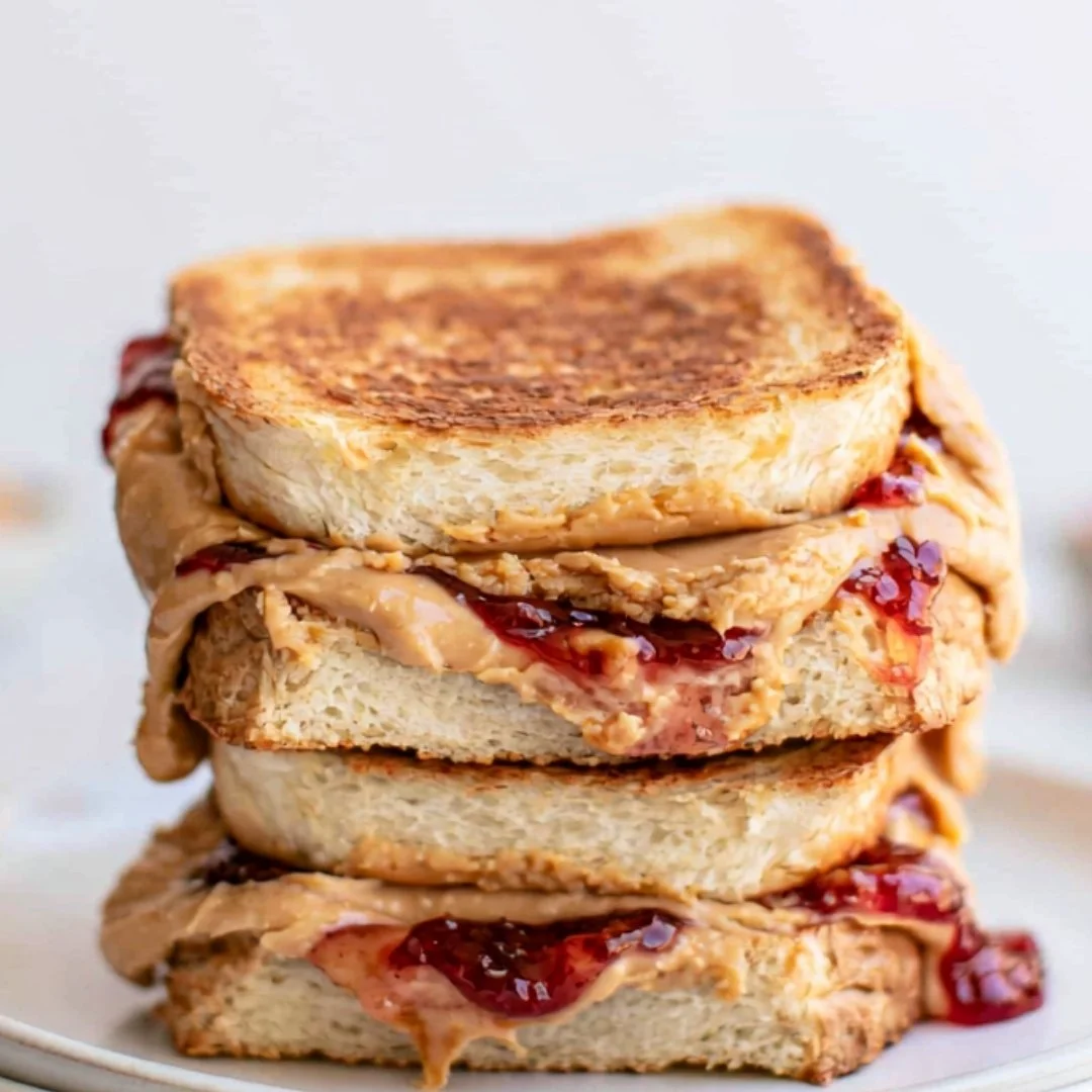 Air Fryer PB&J sandwich with crispy golden edges and luscious peanut butter and jelly filling.