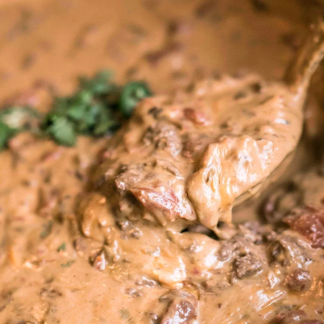 Delicious slow cooker queso dip with melted cheese and spices