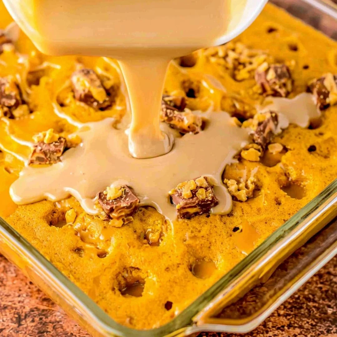 Delicious Pumpkin Spice Poke Cake topped with whipped cream and spices